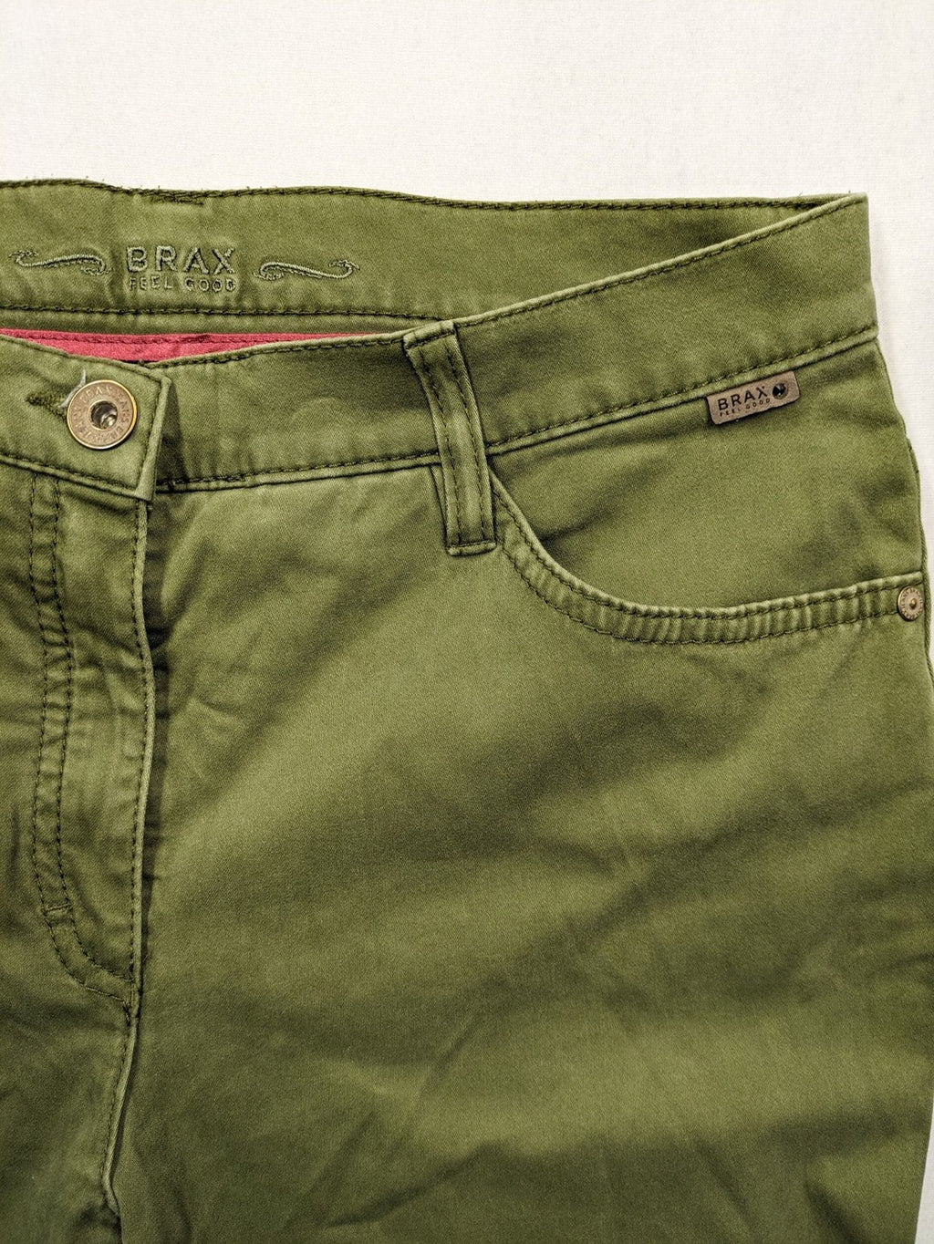 BRAX khaki pants classic five-pocket style with logo patch and zip button closure.