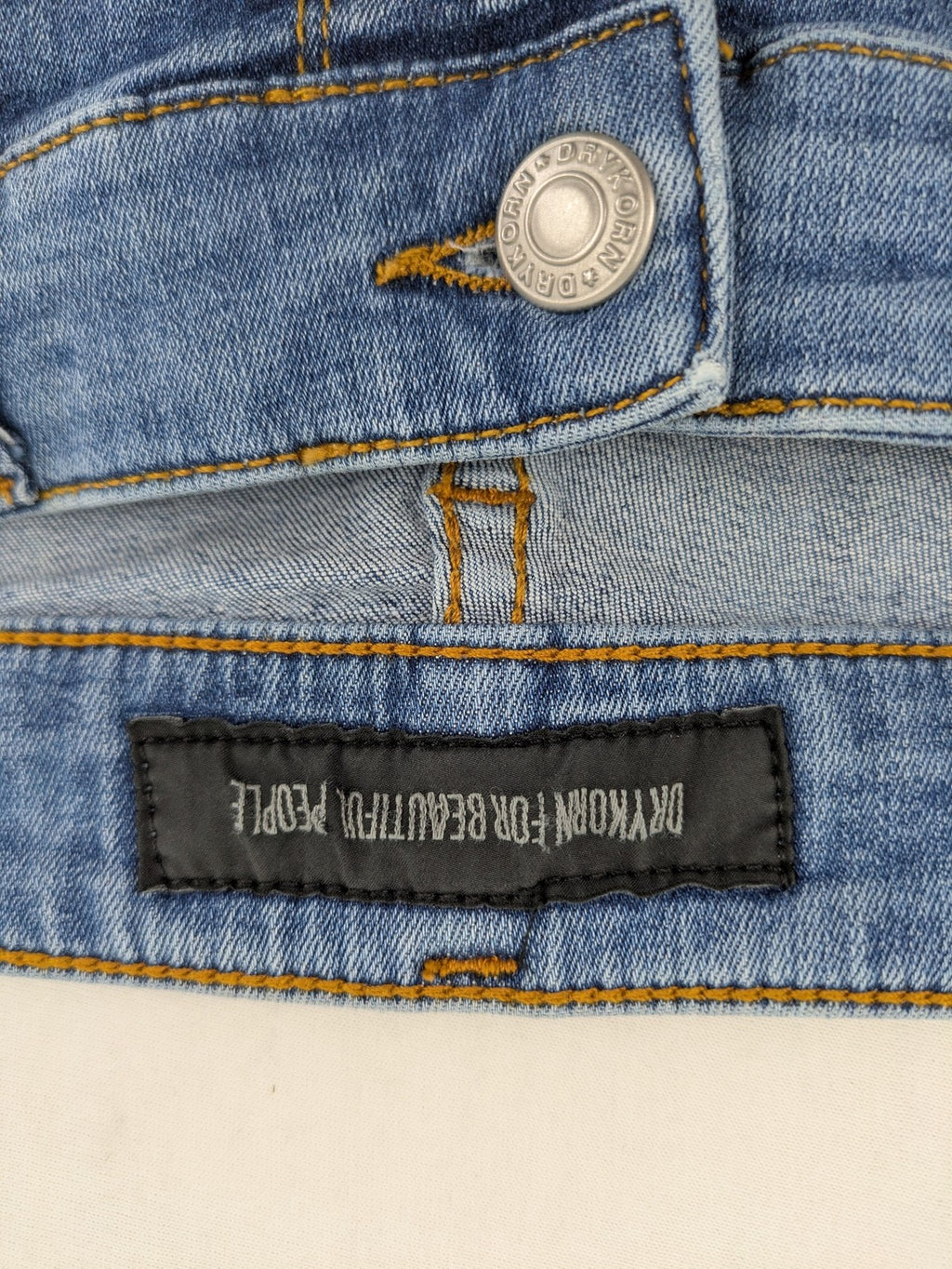 Drykorn blue straight jeans with stretch denim, classic fit, and logo patch on waistband.