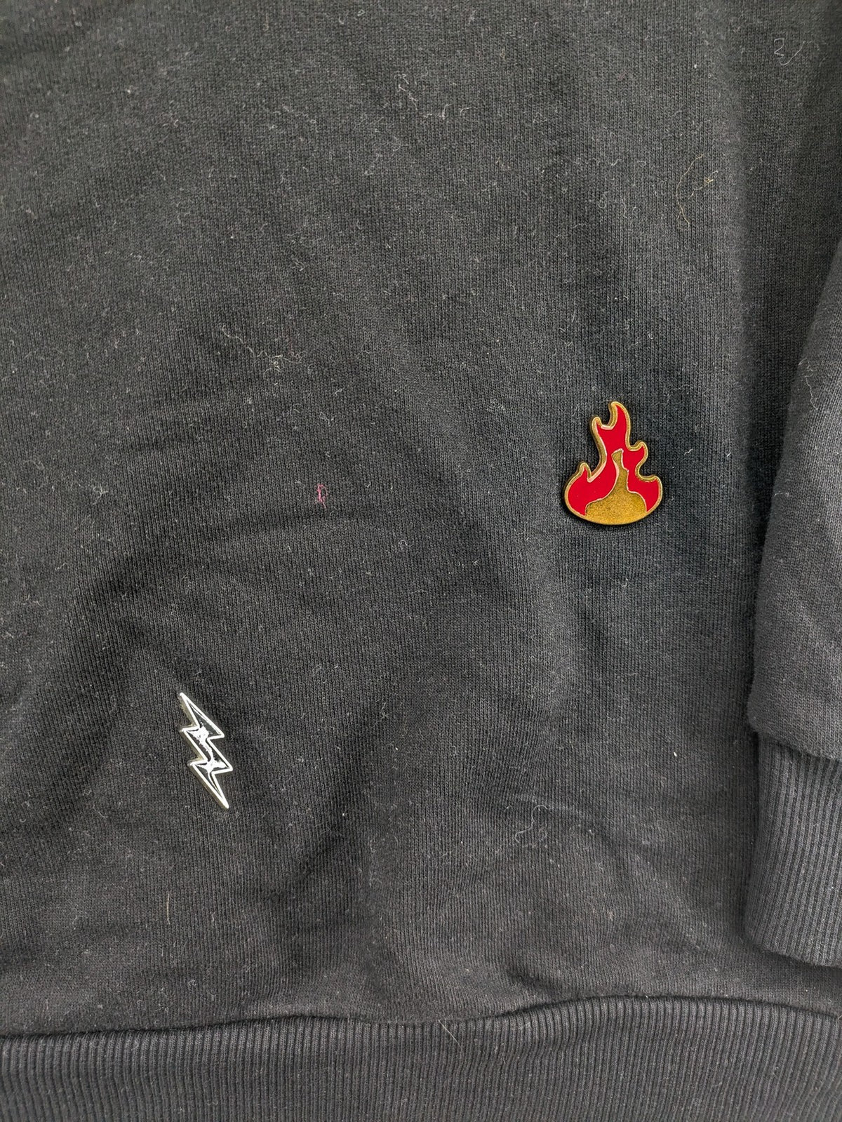 Zara grey turtle neck jumper with skull, scorpion, flame, and eagle embellishments.