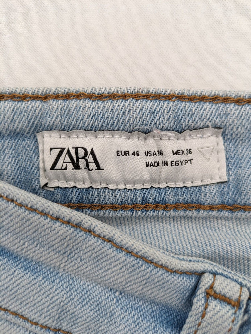 Zara blue straight jeans with distressed knees and classic button fly.