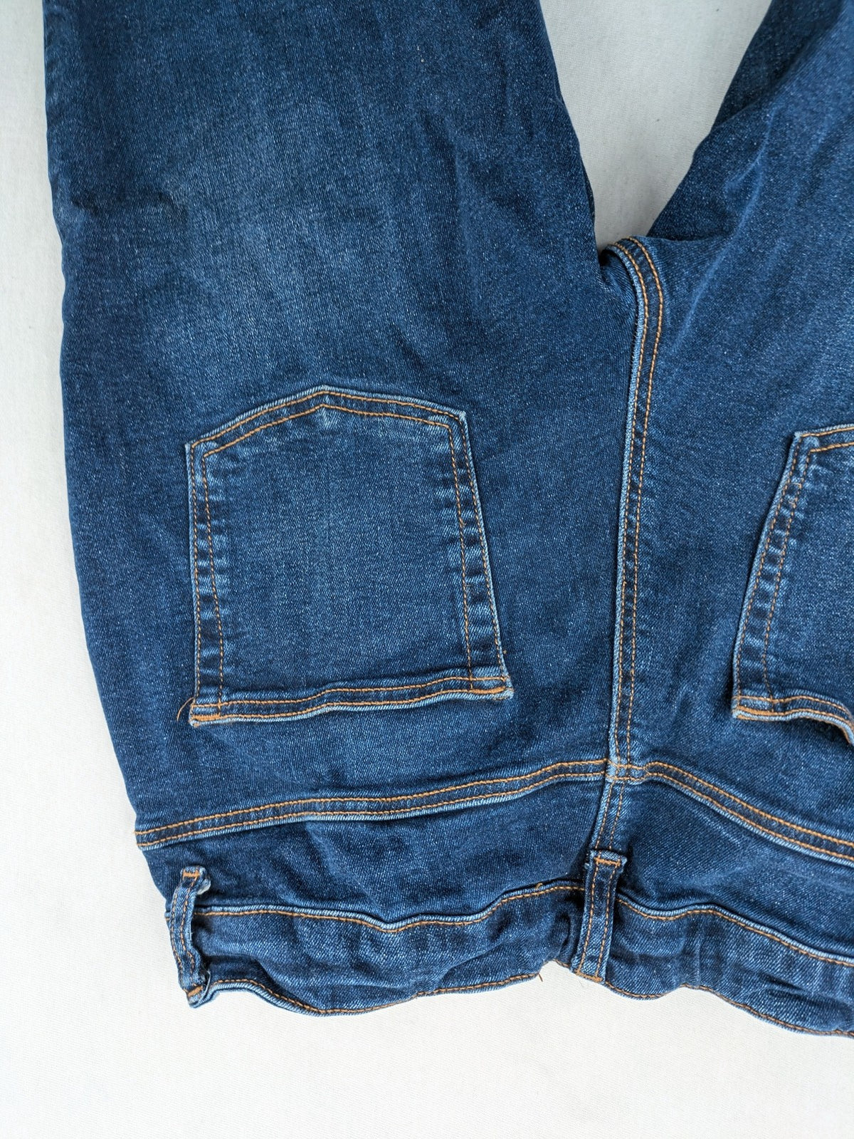 Denim & Co. blue skinny stretch jeans, five-pocket design, dark wash, durable material.