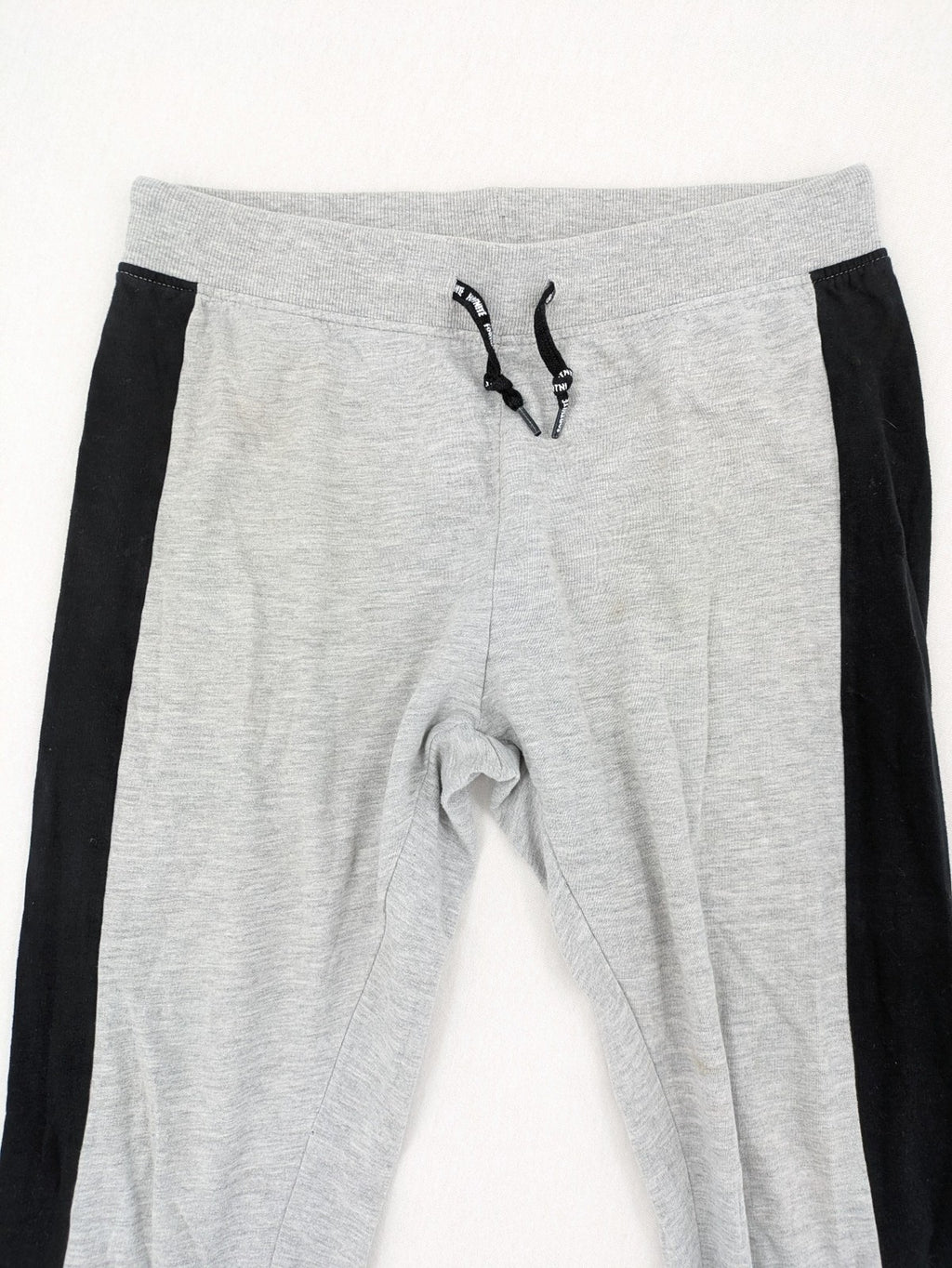 Fortnite pants grey with black side stripes and large logo print, cotton blend material.