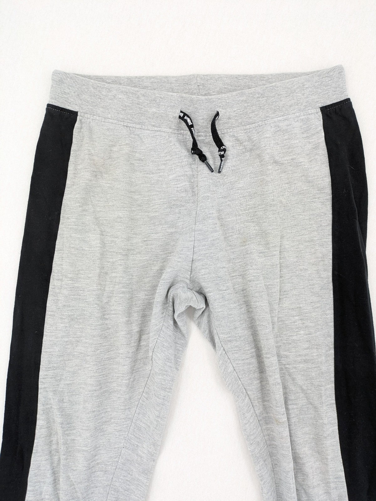 Fortnite pants grey with black side stripes and large logo print, cotton blend material.