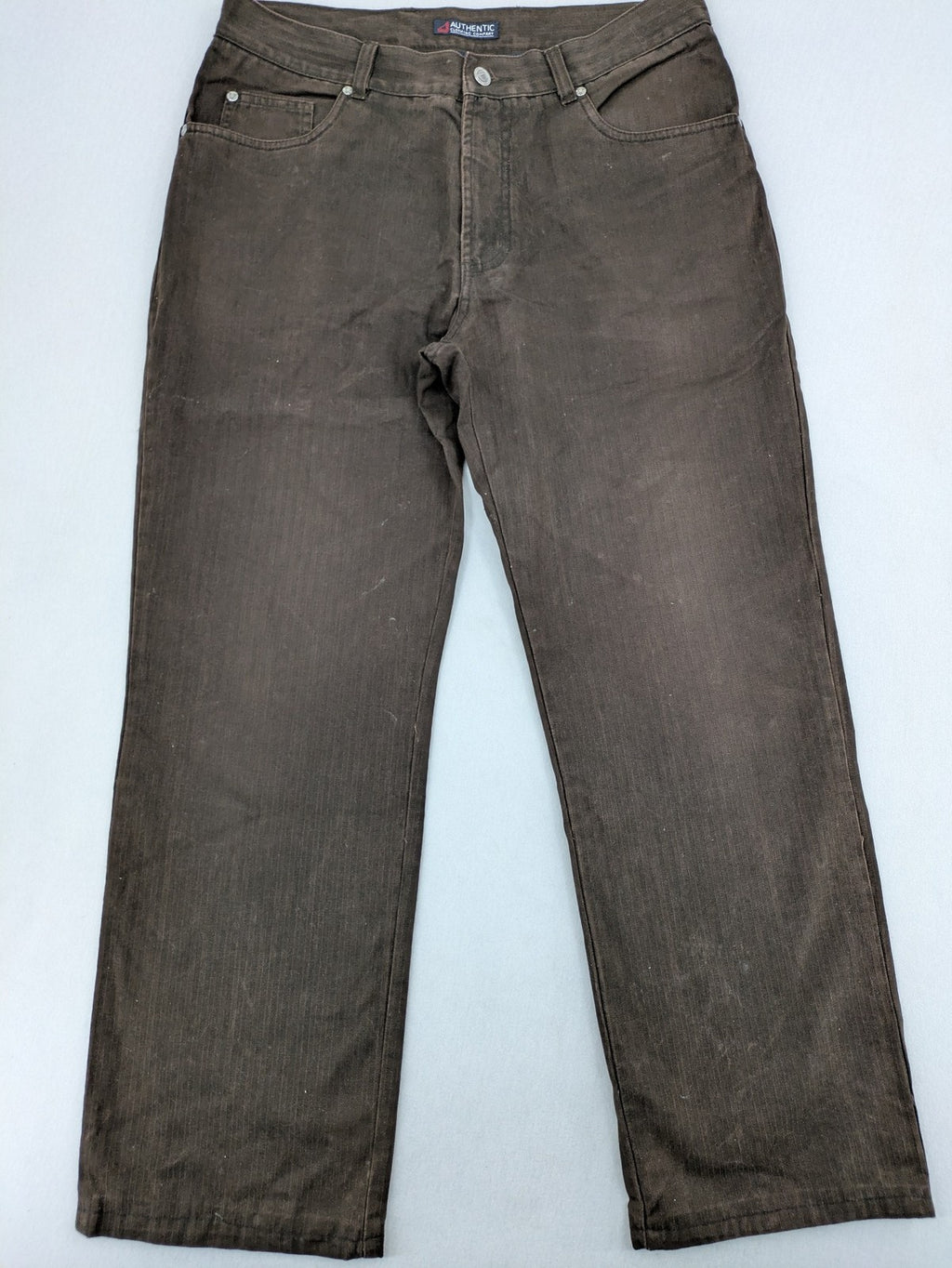 Authentic Clothing Company brown straight jeans with subtle stripe pattern and brand patch.
