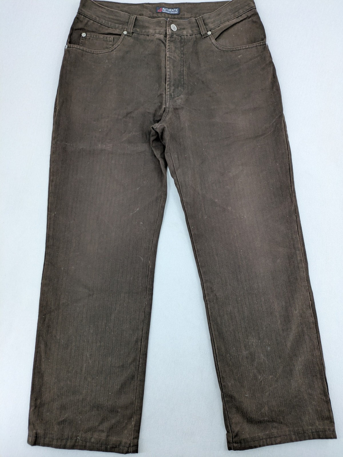 Authentic Clothing Company brown straight jeans with subtle stripe pattern and brand patch.