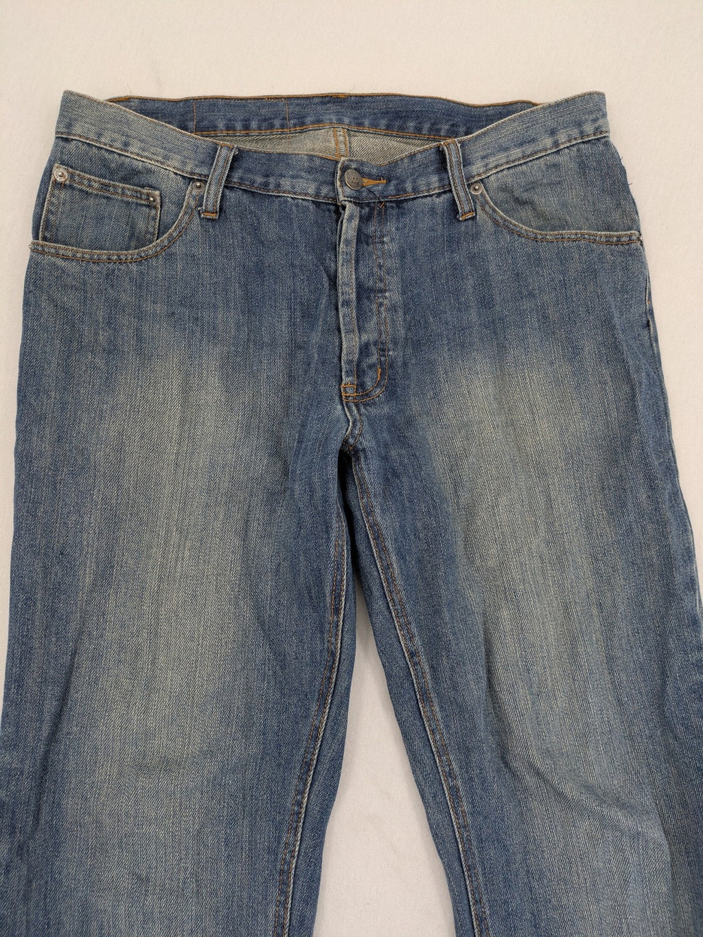 Cheap Monday blue straight jeans with button fly and classic medium wash finish.