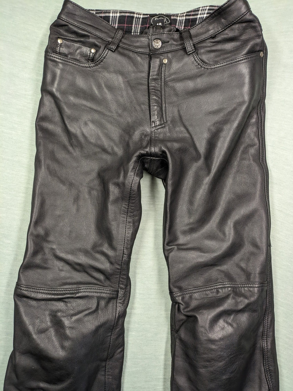 Spirit Motors black leather chaps with red and white accents, 5-pocket style, reinforced knees.