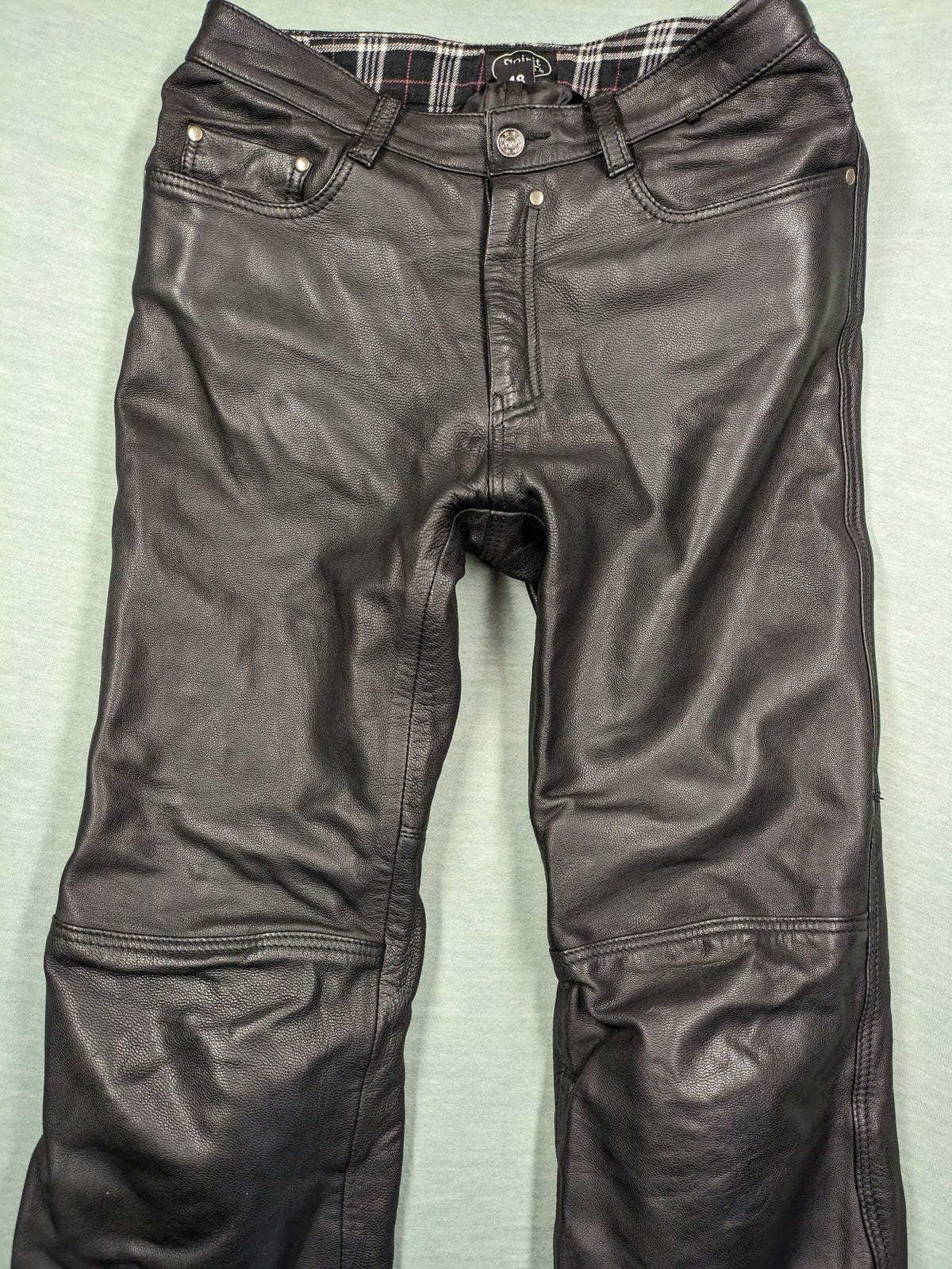 Spirit Motors black leather chaps with red and white accents, 5-pocket style, reinforced knees.