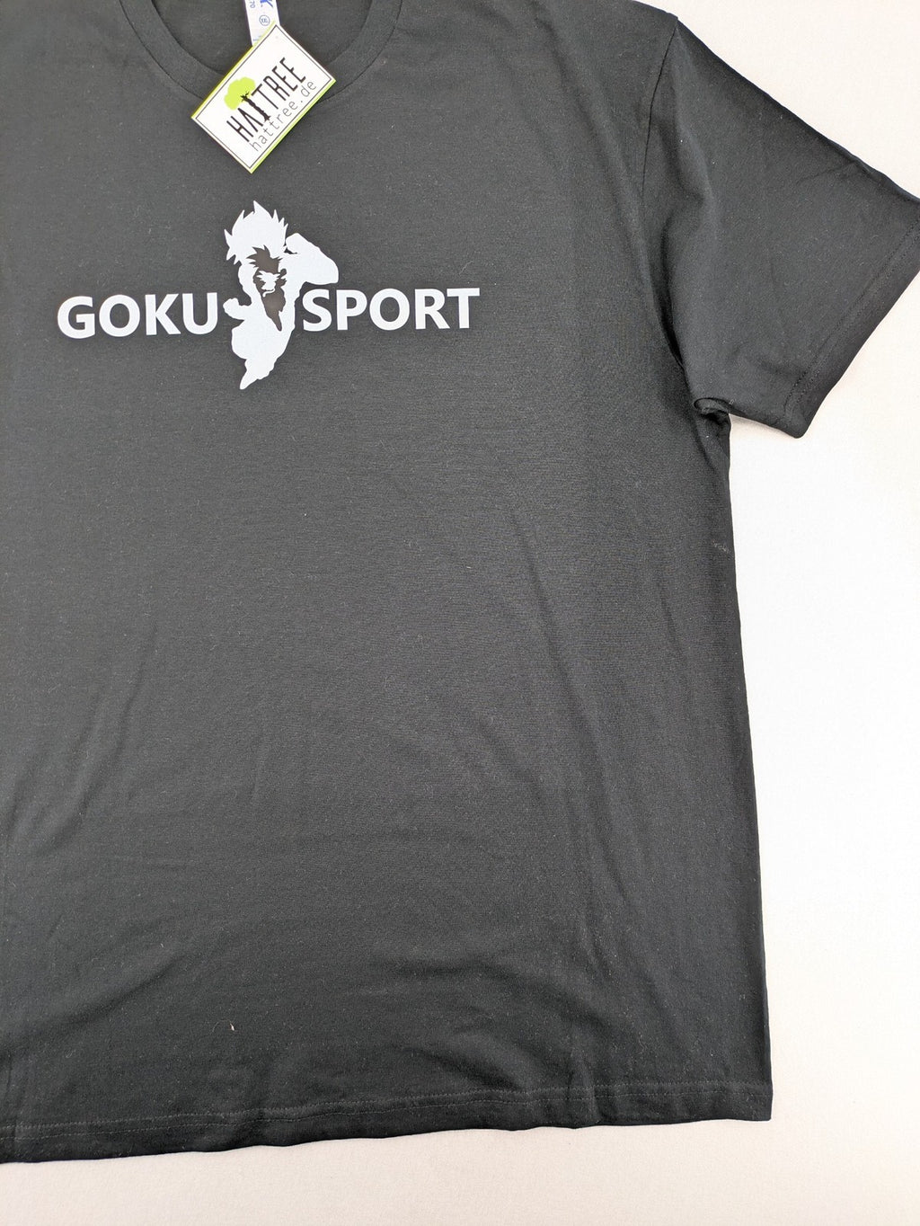 Dragon Ball Z blue graphic t-shirt featuring Goku Sport text and soft cotton material.