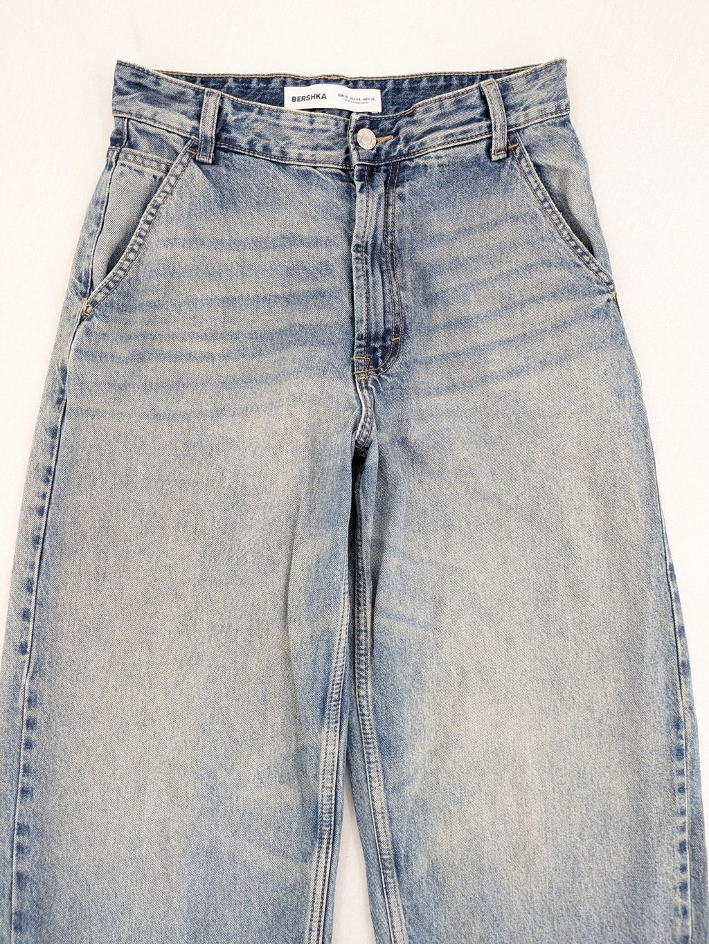 Bershka blue wide leg jeans high waist baggy style with light wash and cotton material.