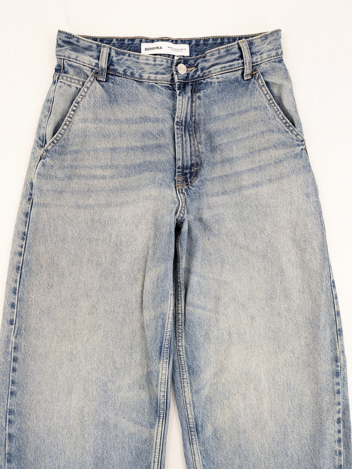 Bershka blue wide leg jeans high waist baggy style with light wash and cotton material.