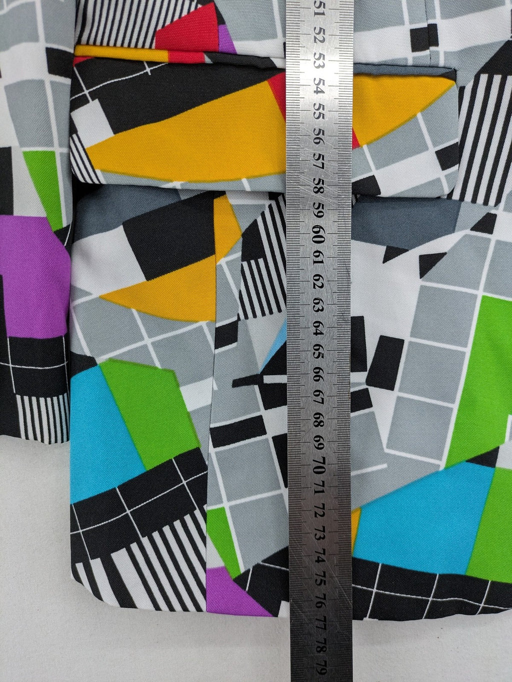 Opposuits blue and green blazer with vibrant geometric pattern and purple satin lining.