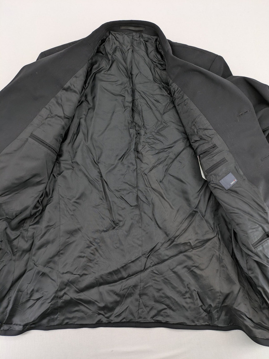 Jake*s pink jacket classic design with falling lapel and three-button closure.