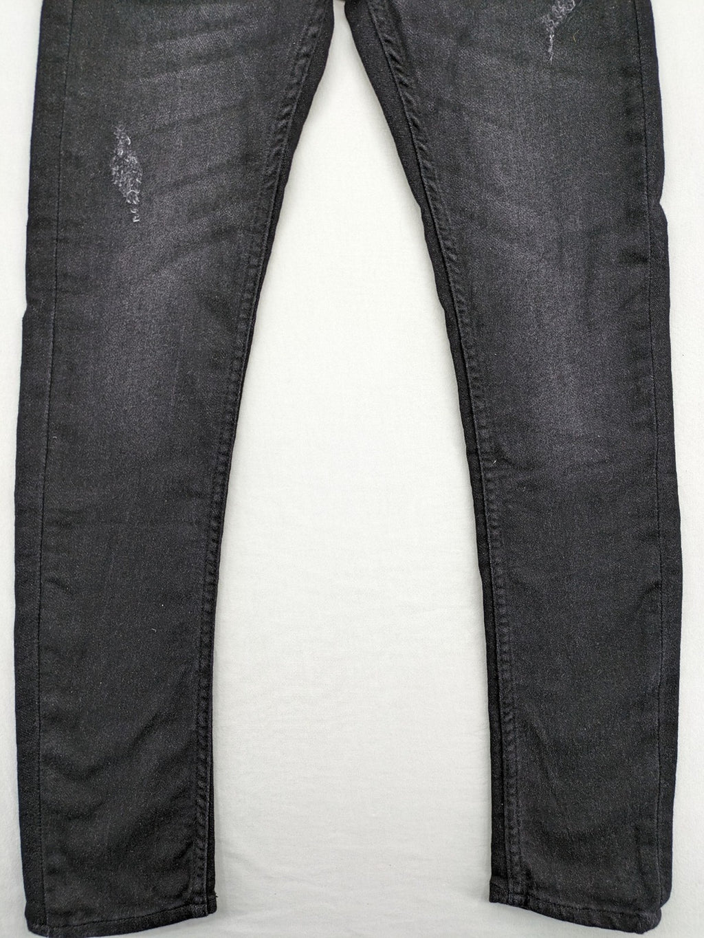 Skinny black straight jeans with distressed details and logo, made from durable denim.