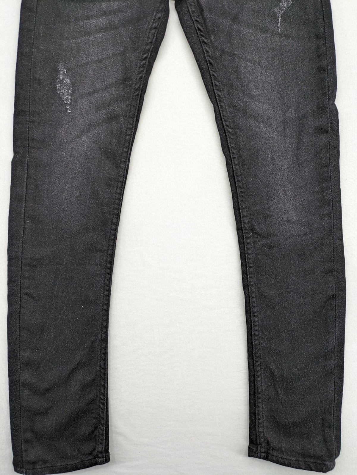 Skinny black straight jeans with distressed details and logo, made from durable denim.