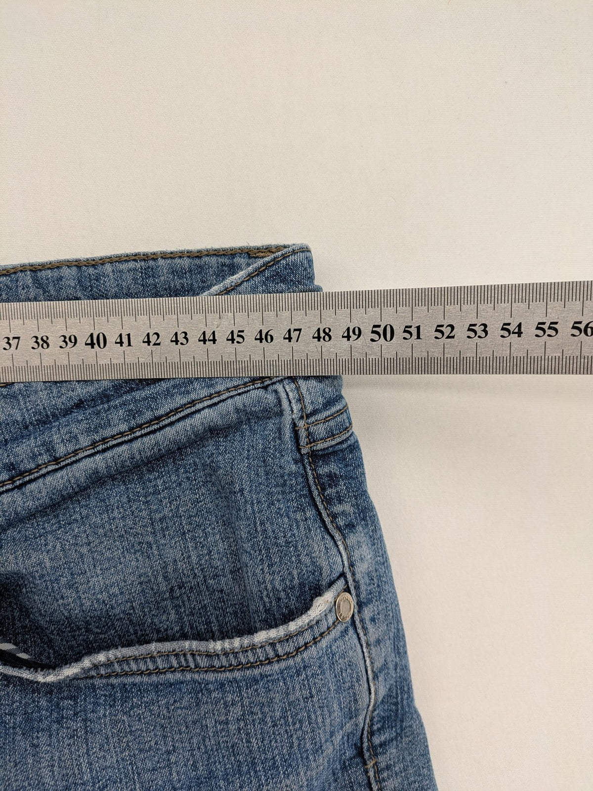 Digel blue straight jeans with classic medium wash and durable cotton denim material.