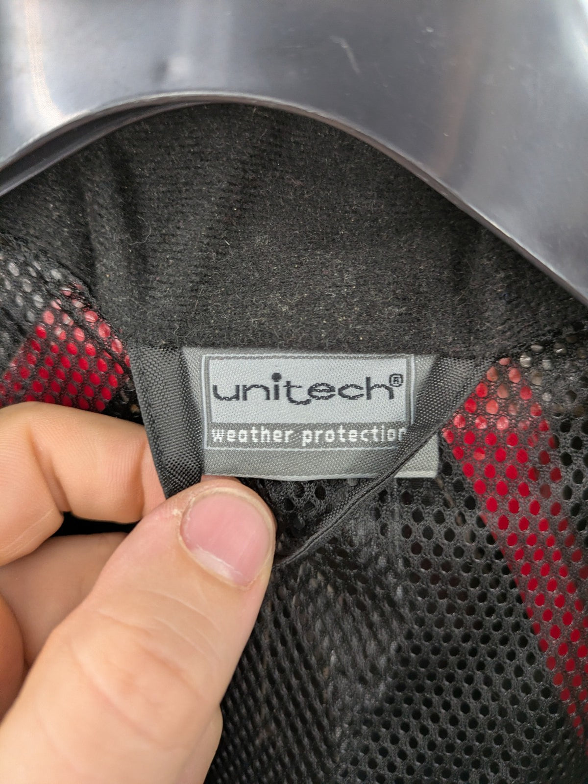 Unitech black rain suit with red reflective stripes and full zipper, size M.
