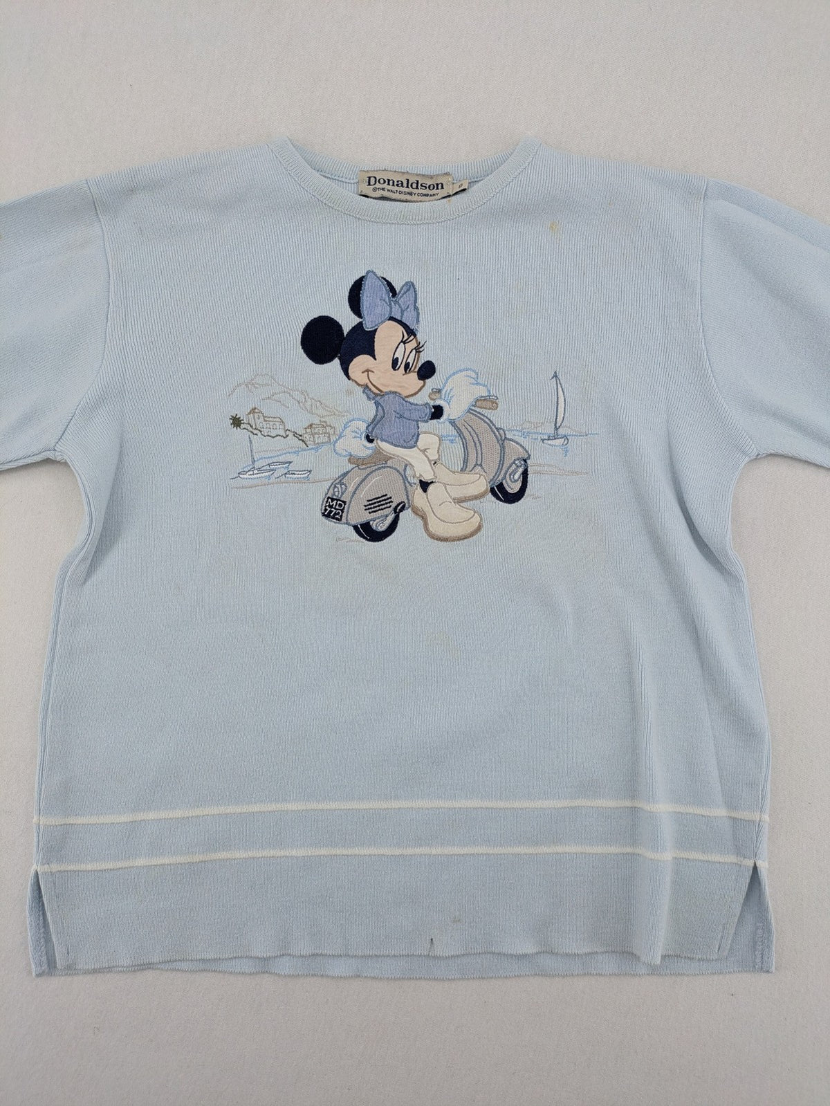 Donaldson multi turtle neck jumper light blue with embroidered Minnie Mouse graphic and ribbed texture.