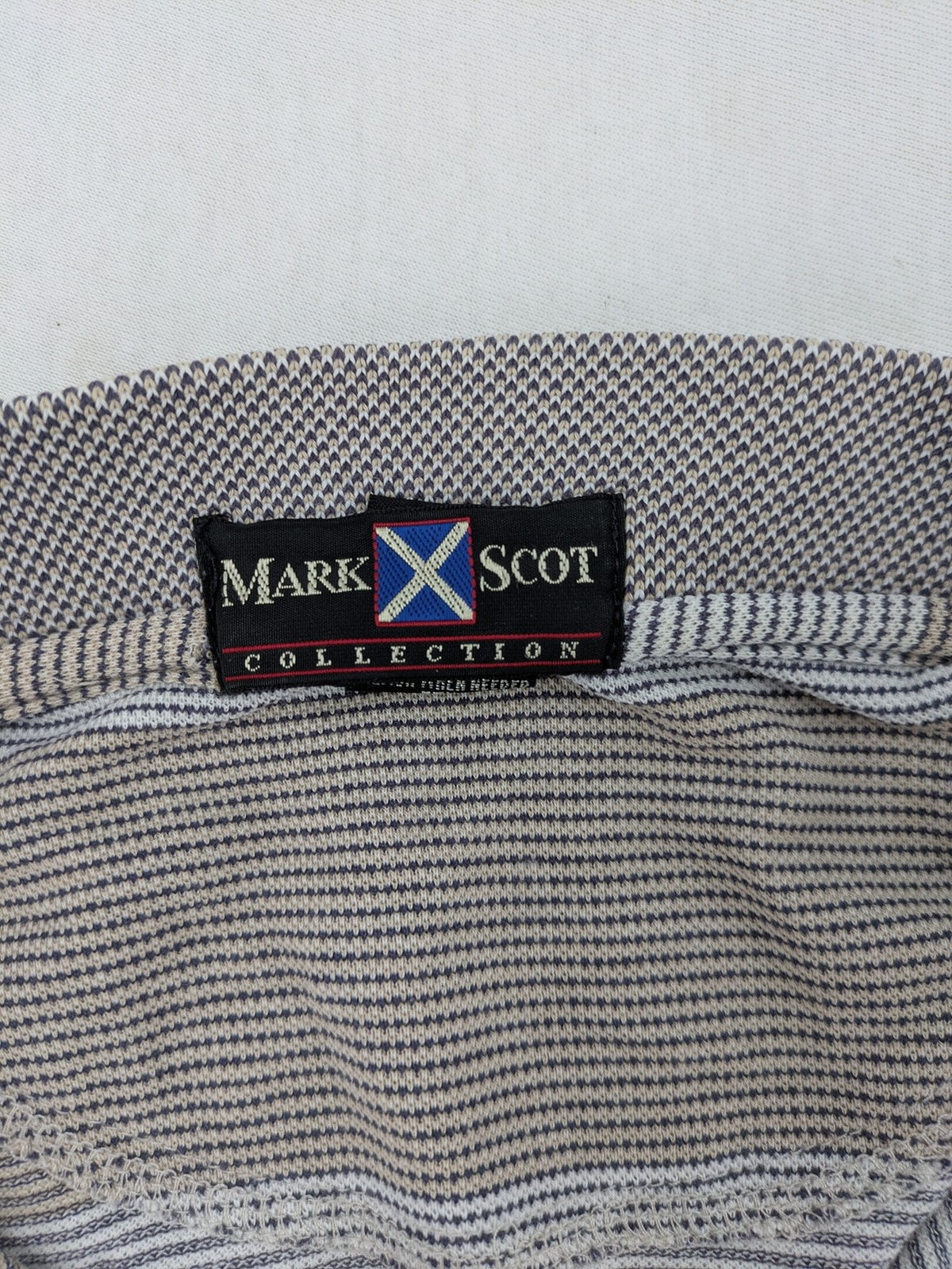 Mark Scot Collection grey and tan striped polo shirt with classic collar and logo.