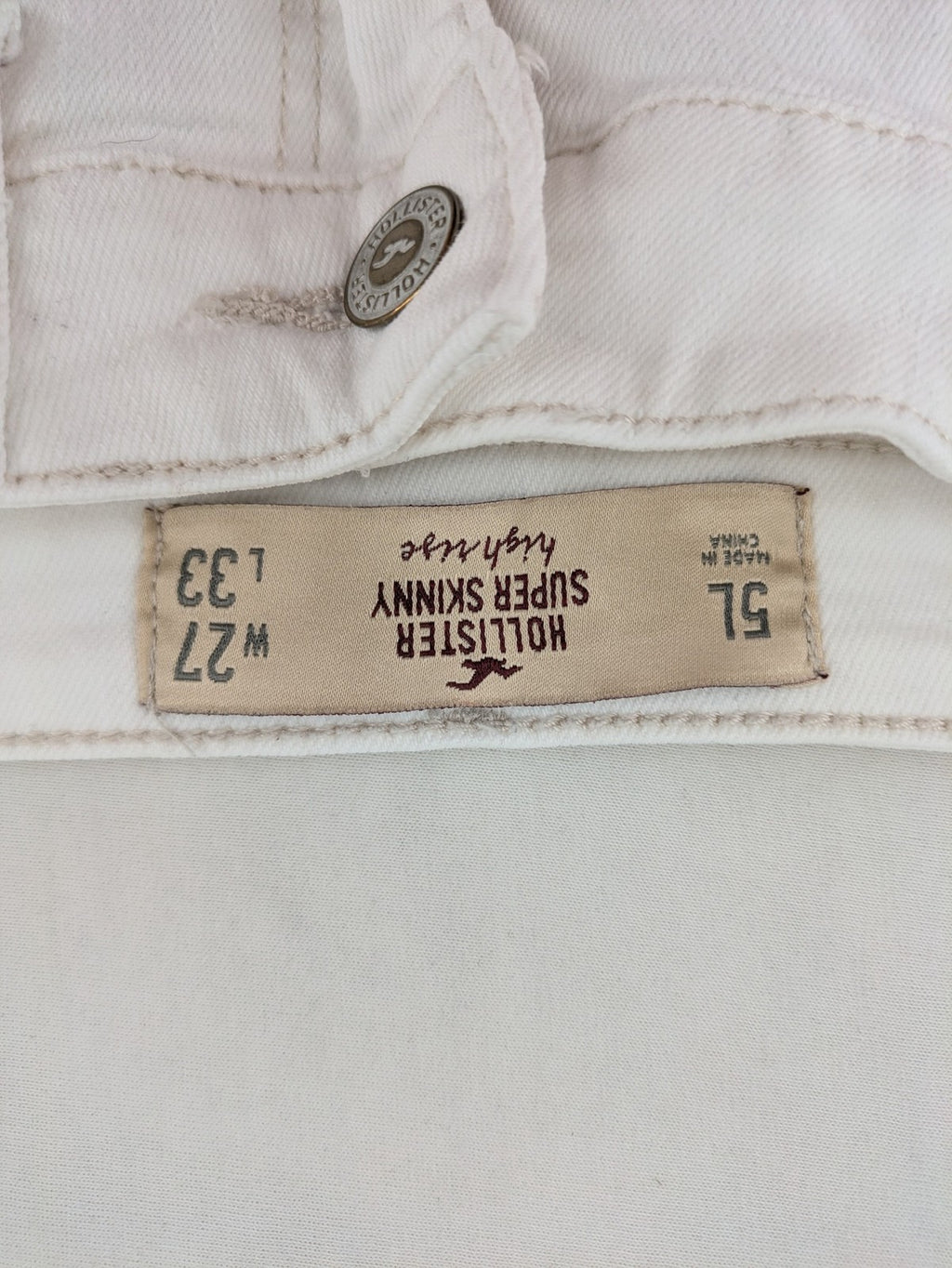 Hollister white super skinny high rise jeans with classic 5-pocket design and zipper closure.