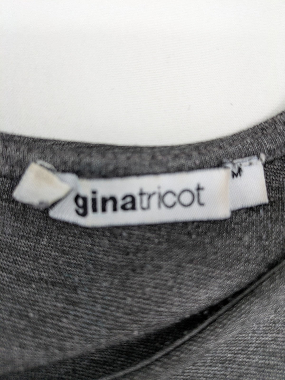Ginatricot grey A-line skater dress with 3/4 sleeves and visible back zipper.