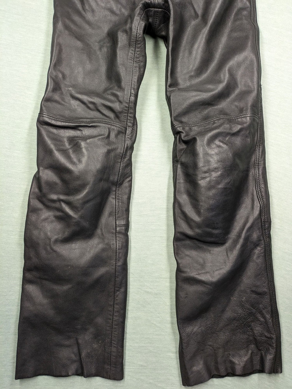 Spirit Motors black leather chaps with red and white accents, 5-pocket style, reinforced knees.