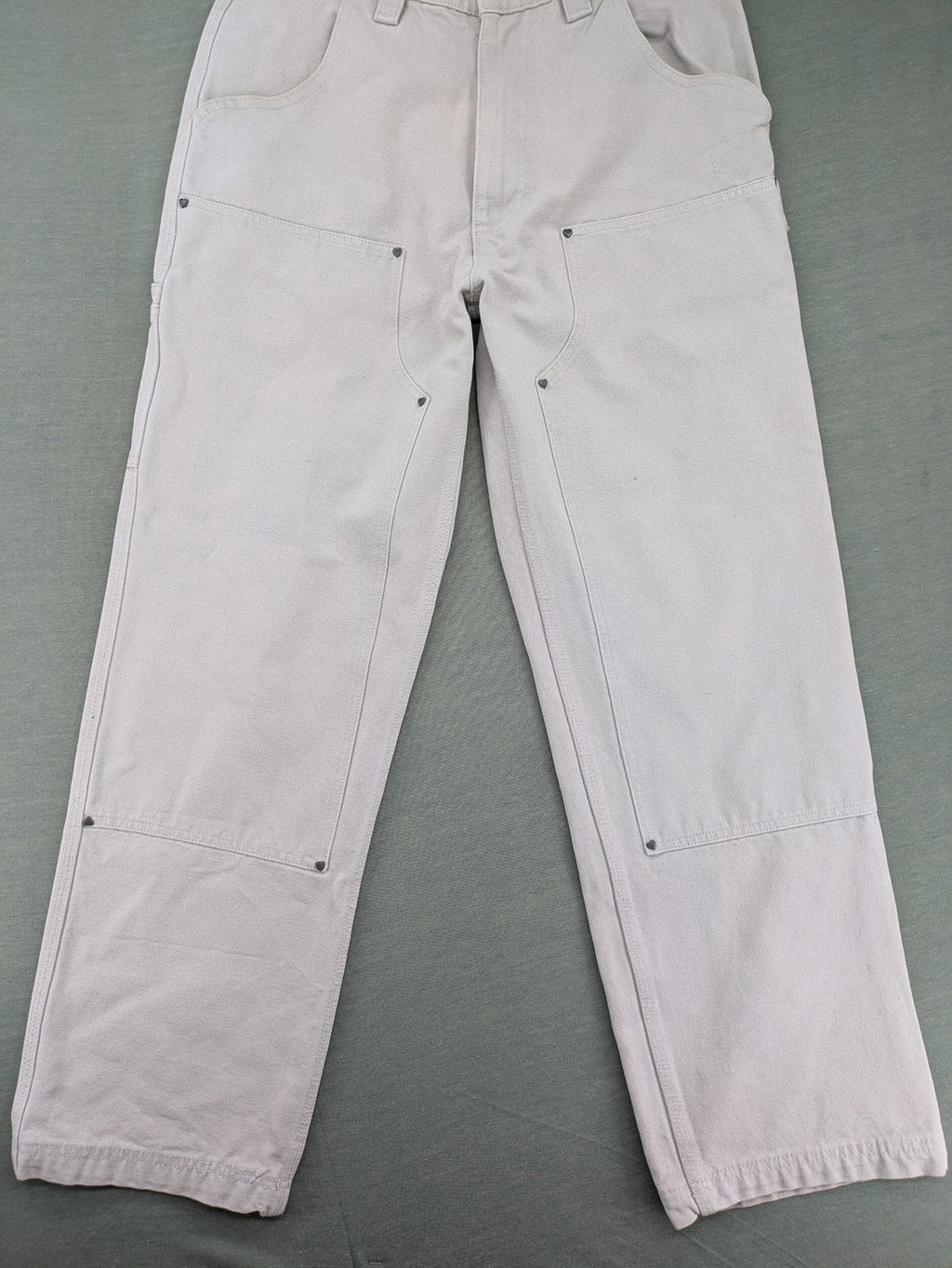 NUDE beige pants with double knee reinforcements and multiple utility pockets.