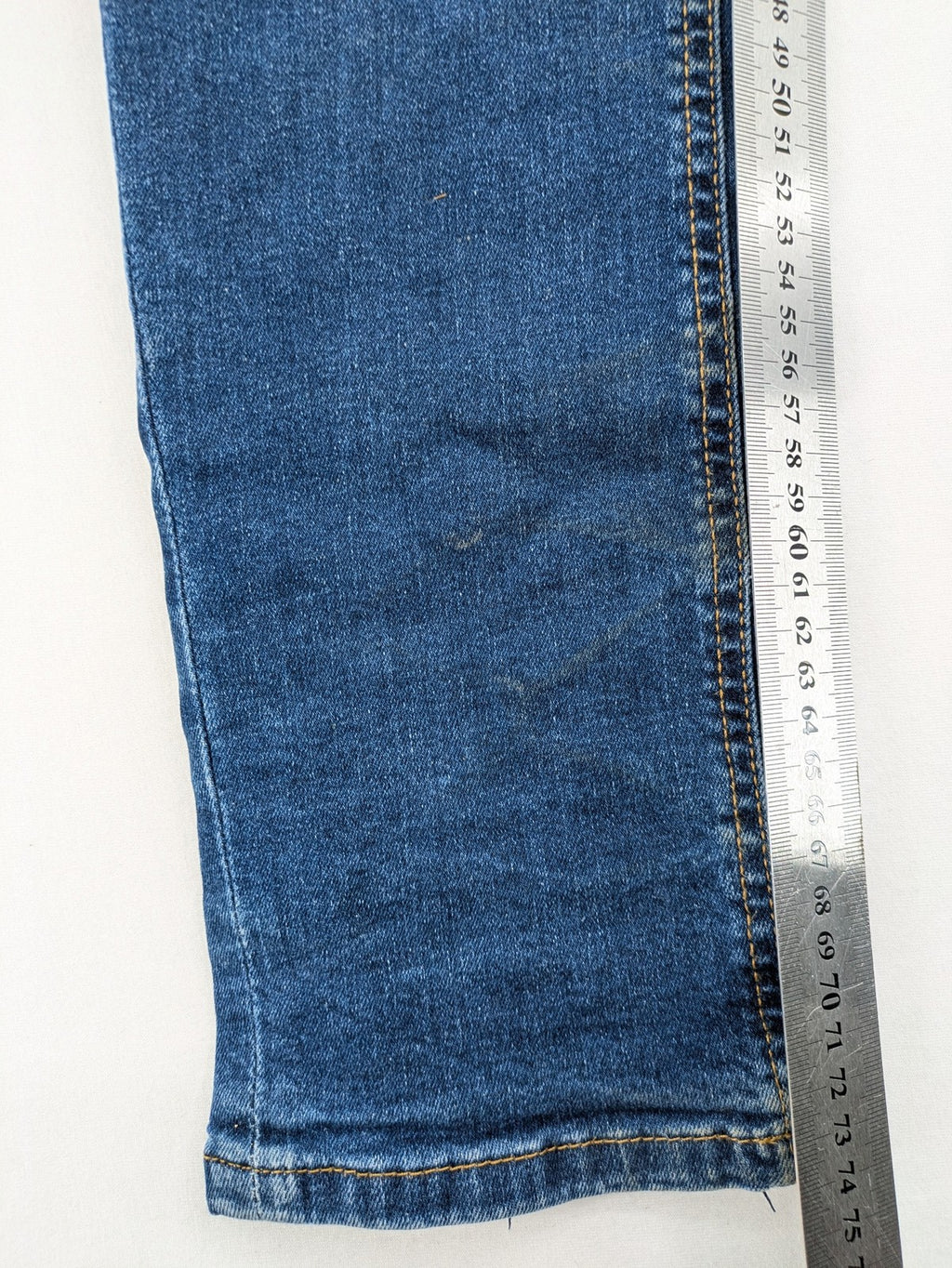 Denim & Co. blue skinny jeans with distressed ripped details and adjustable waistband.