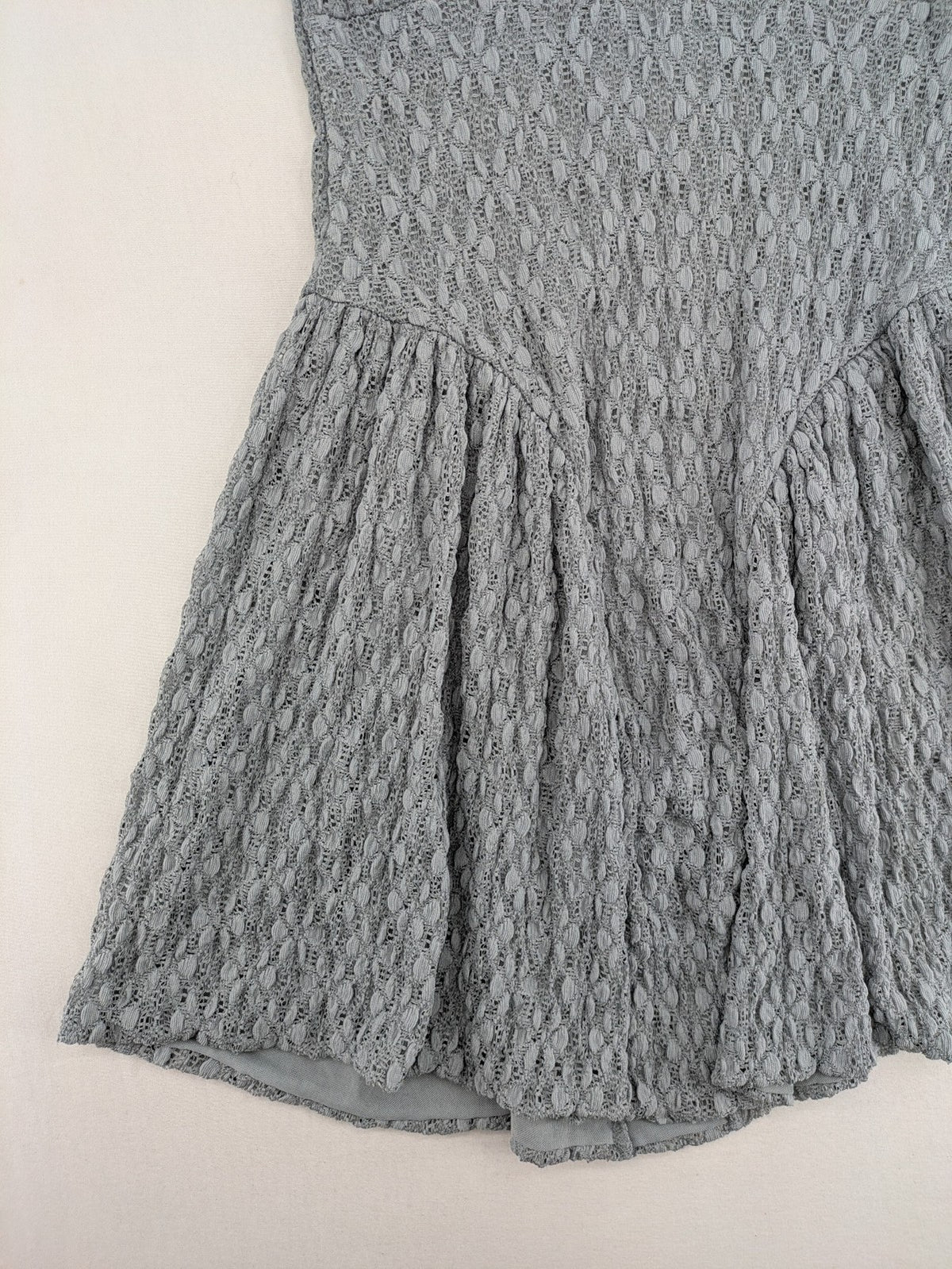 Zara grey mini dress with V-neck, puff sleeves, and textured fabric pattern.