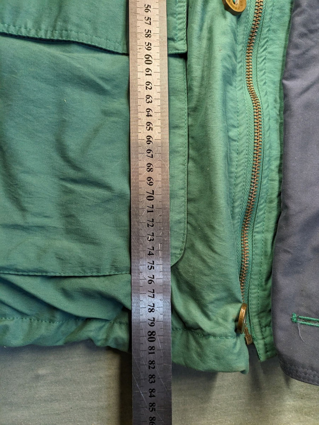 Canda green parka coat with dark lining, multiple pockets, and Micro Membrane technology.