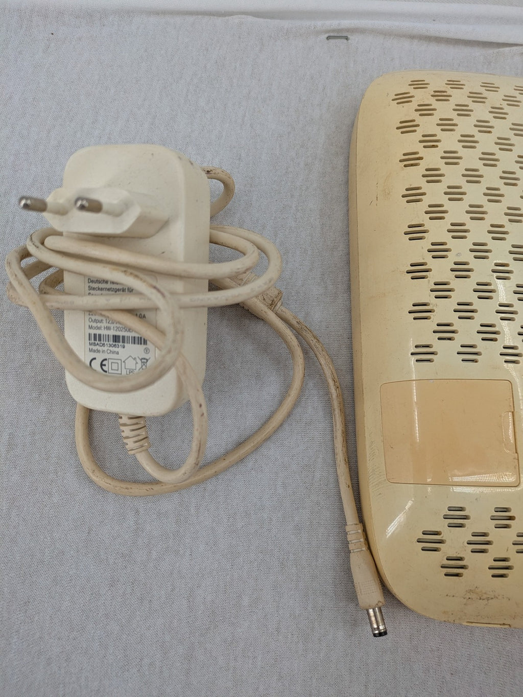 Vodafone wireless router beige and black with multiple LAN ports and USB connection.