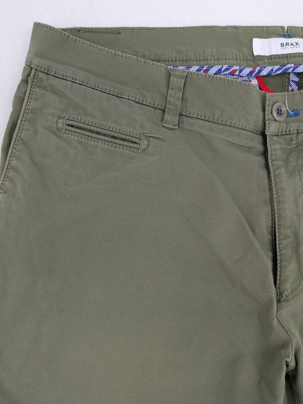 BRAX green chino pants flat-front design with zipper and buttoned back pockets.