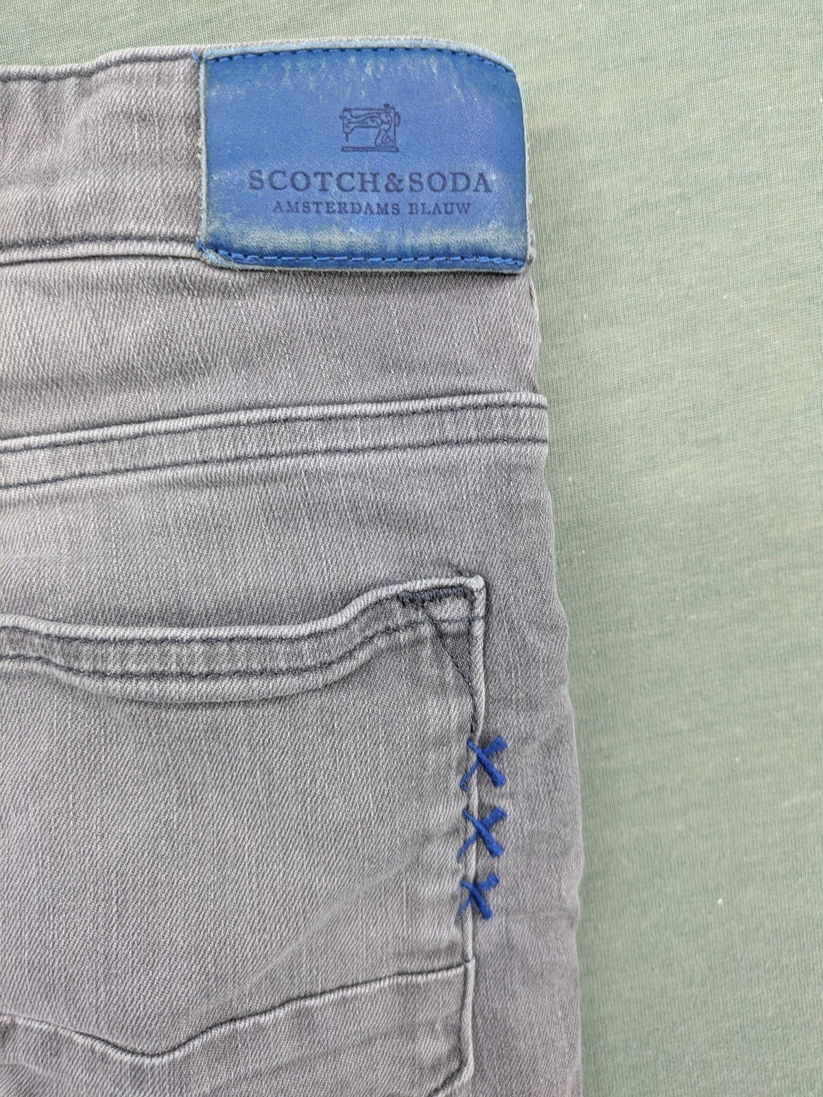 Scotch & Soda grey straight jeans with classic five-pocket design and logo patch.