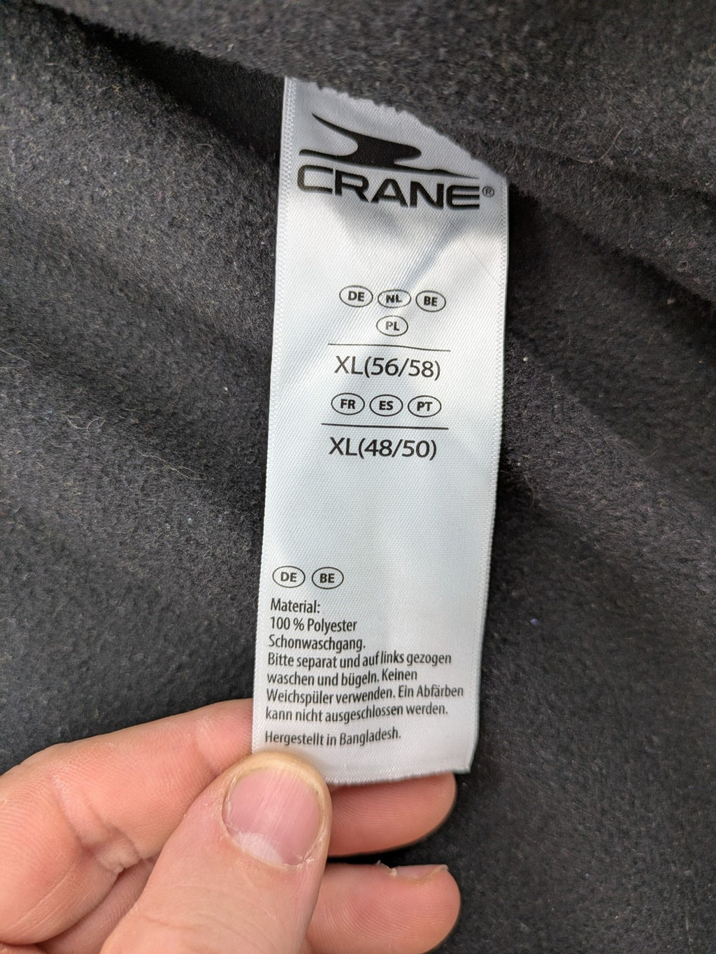 Crane beige and black fleece jacket full zip with cream accents and zippered pockets.