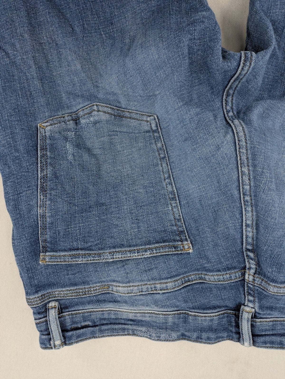 Zara blue straight jeans with distressed ripped knees and button-fly closure.