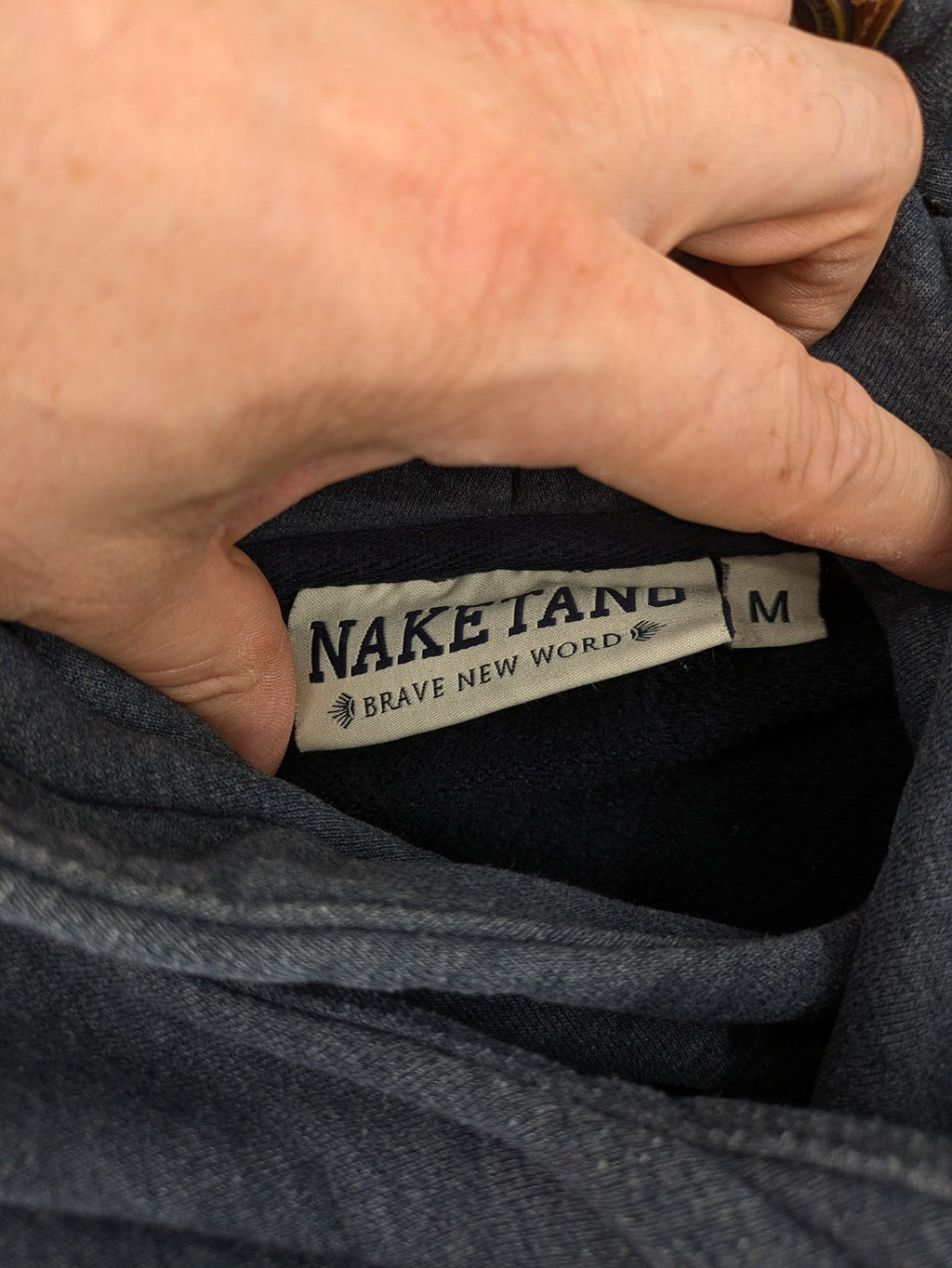Naketano multicolor turtle neck jumper with button placket and anchor patches.