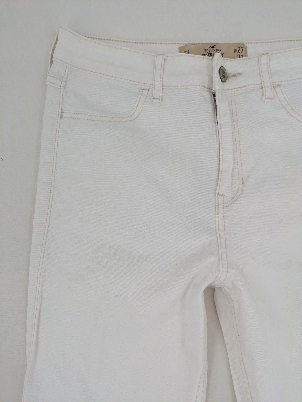 Hollister white super skinny high rise jeans with classic 5-pocket design and zipper closure.