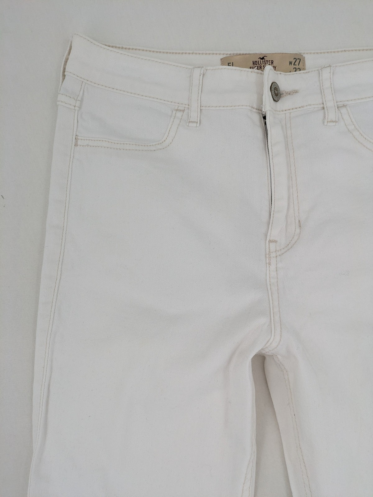 Hollister white super skinny high rise jeans with classic 5-pocket design and zipper closure.