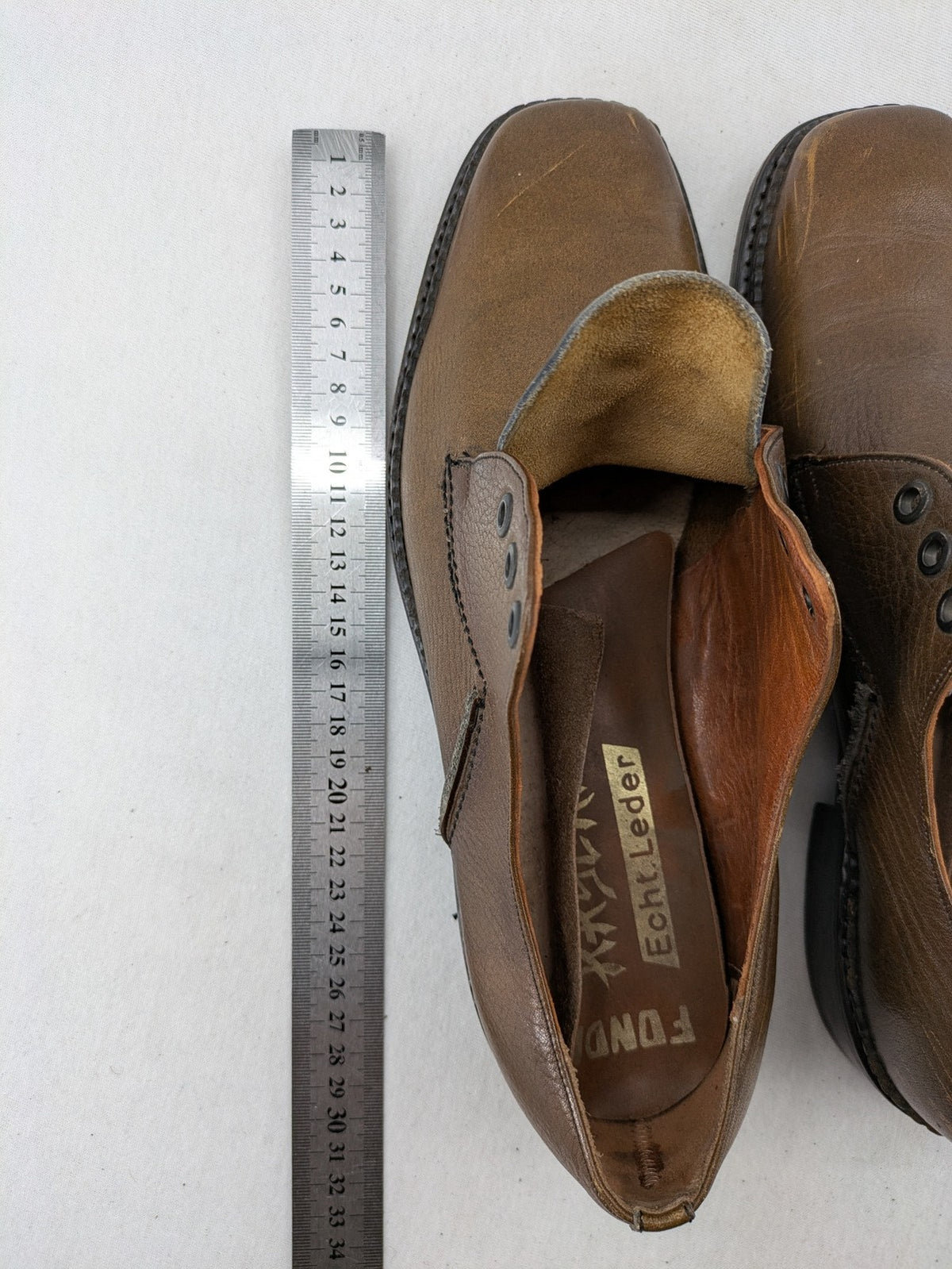Fonda brown deck shoes genuine leather square toe design with decorative stitching.