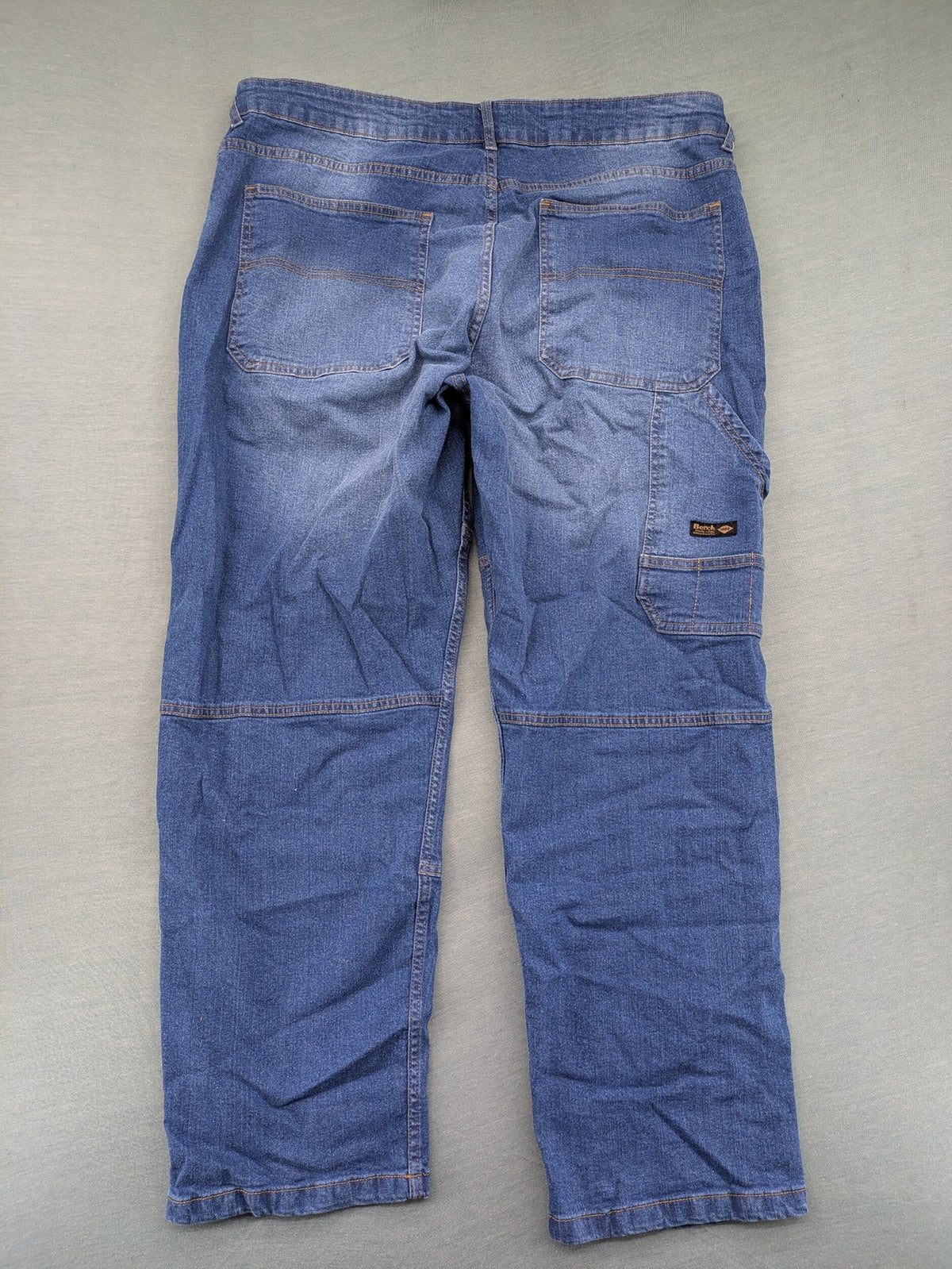 Bench blue straight jeans with reinforced knees and multiple cargo pockets.