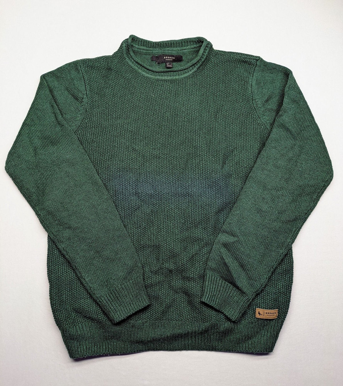 Broken Standard turtle neck jumper green waffle knit texture with classic round neckline.