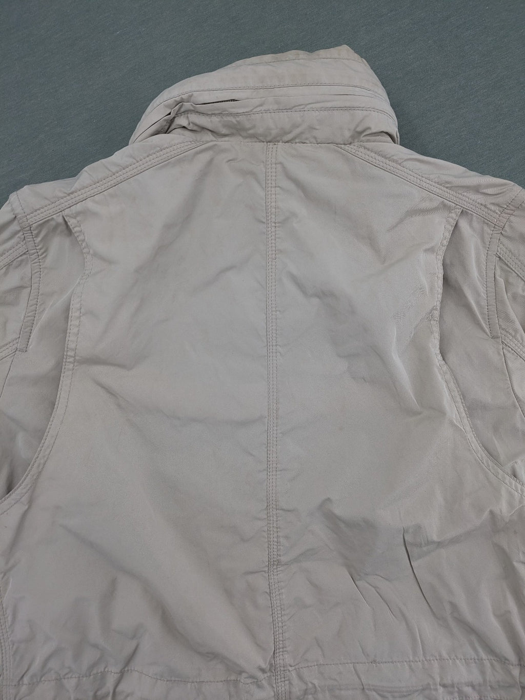 Camp David beige field jacket with logo patches, standing collar, and multiple pockets.