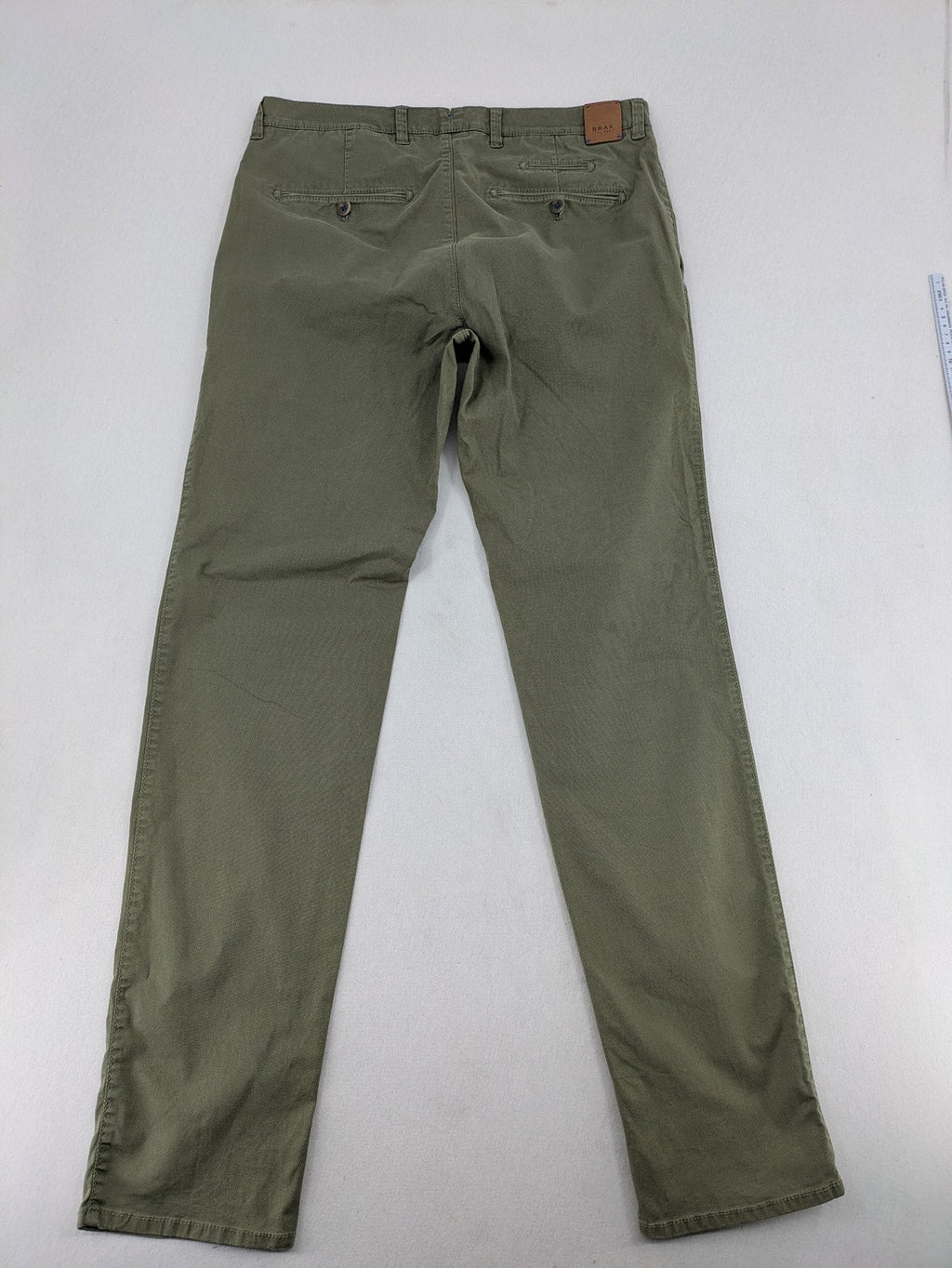 BRAX green chino pants flat-front design with zipper and buttoned back pockets.