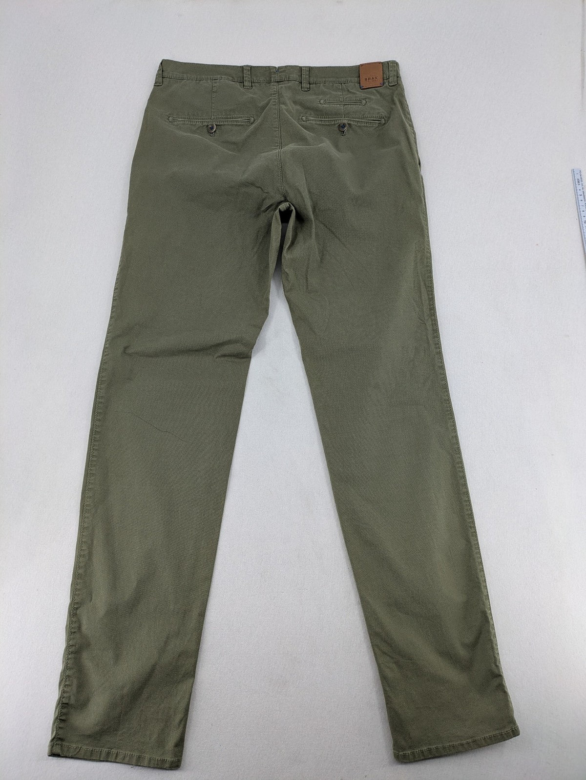 BRAX green chino pants flat-front design with zipper and buttoned back pockets.
