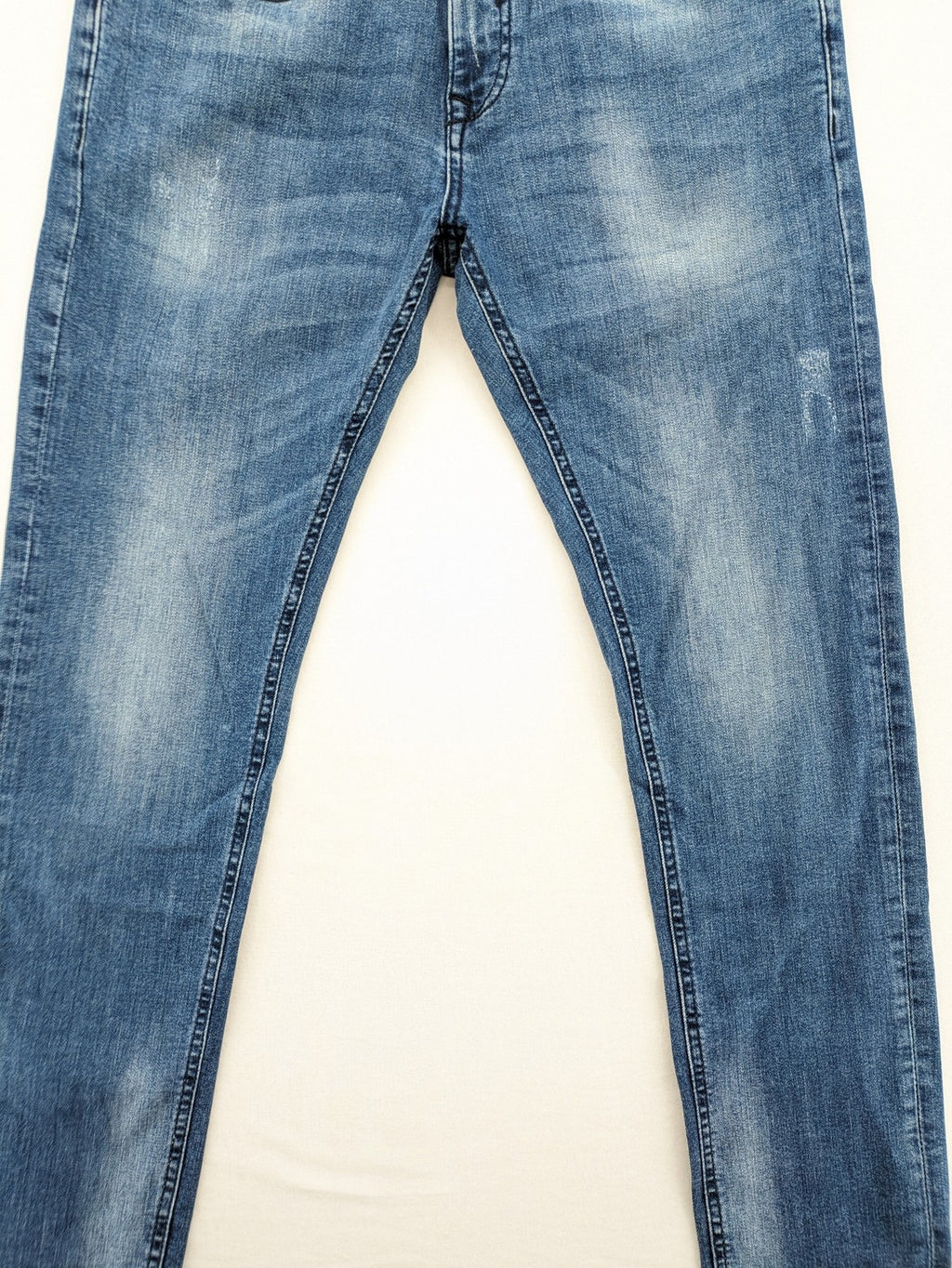 Crosshatch blue slim fit jeans with faded wash and logo patch on back pocket.