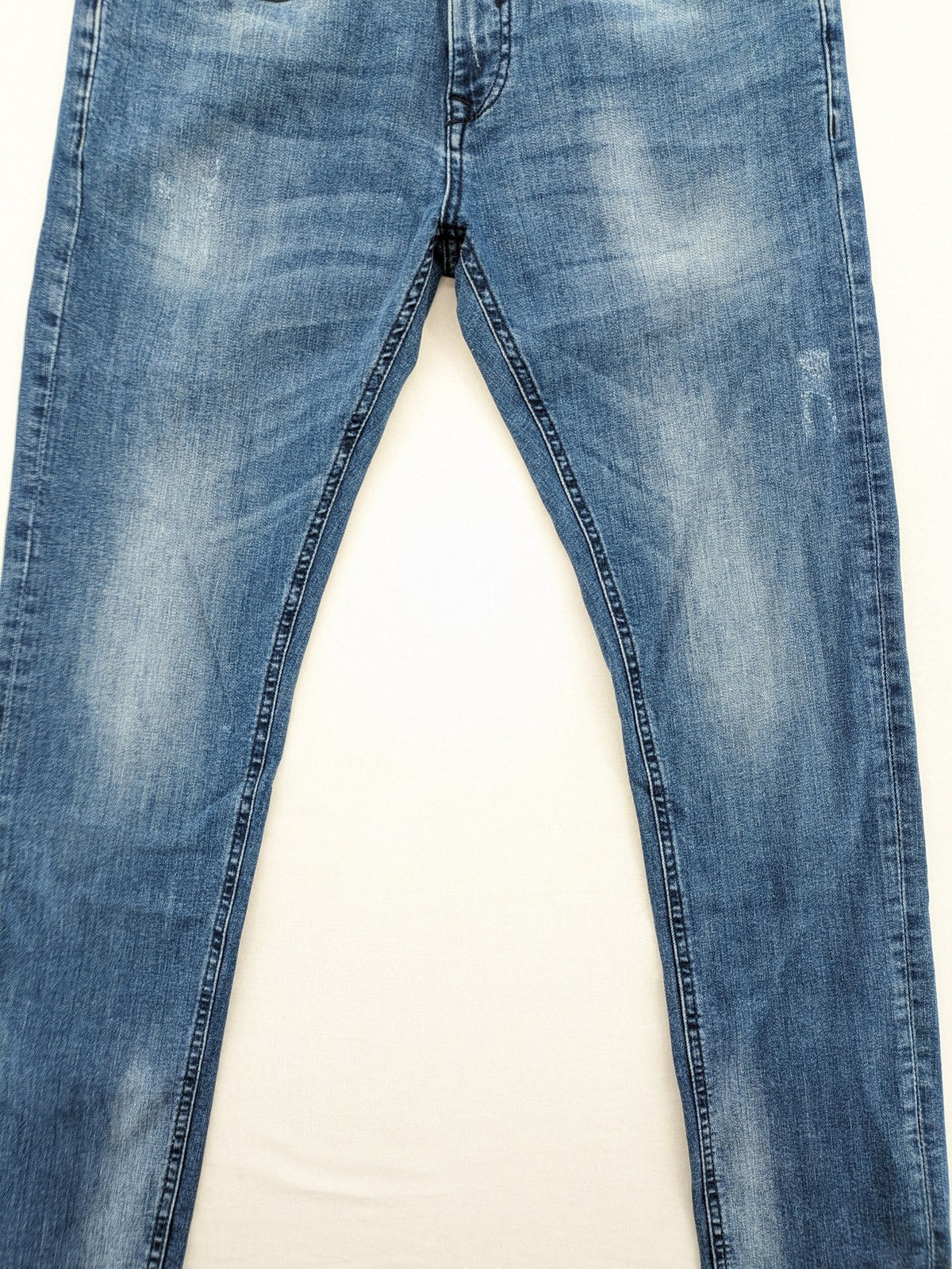 Crosshatch blue slim fit jeans with faded wash and logo patch on back pocket.