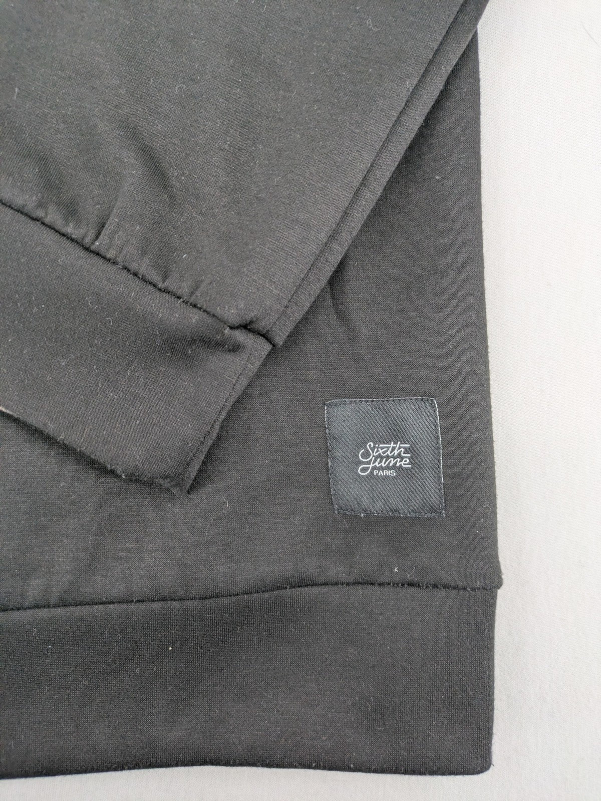 Sixth June black sweatshirt with Gothic "Propaganda" graphic print and logo details.