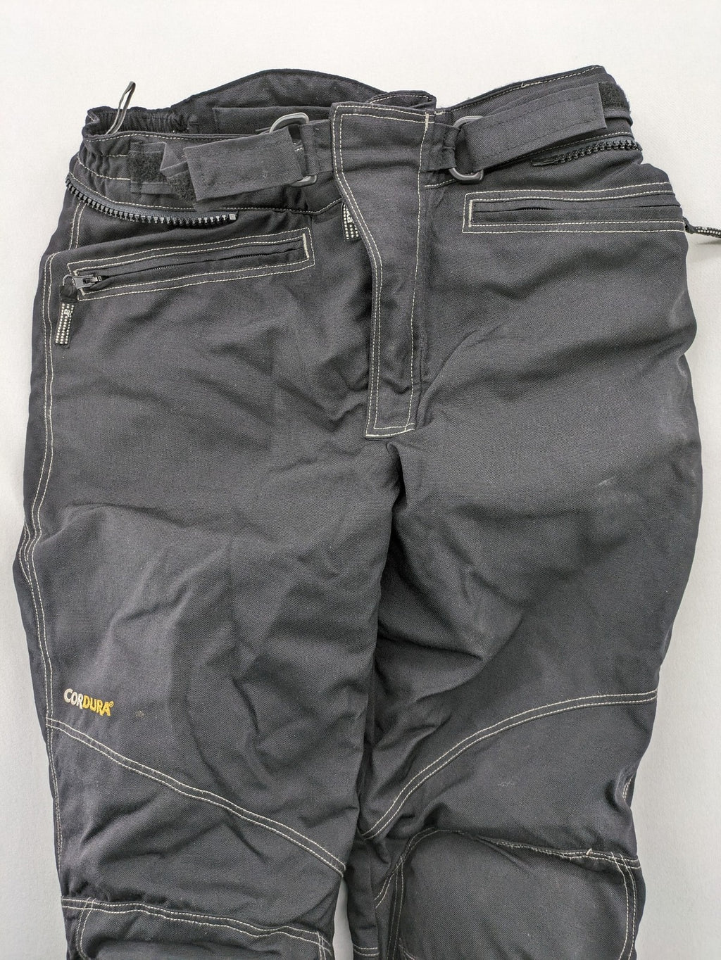 Rukka black motorcycle chaps with grey accents and CE knee protectors, made from durable Cordura.