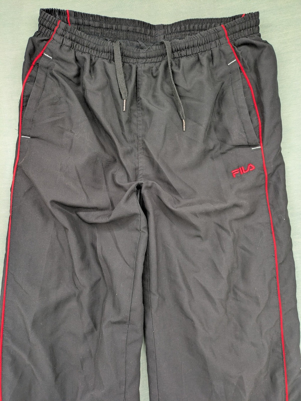 Fila grey jogging pants with red piping and embroidered logo on thigh.