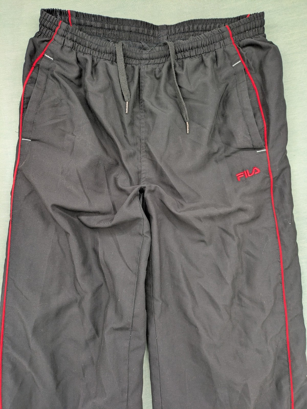 Fila grey jogging pants with red piping and embroidered logo on thigh.